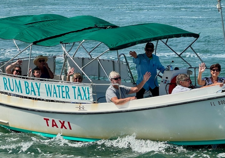 Passengers enjoying a ride on the Rum Bay Water Taxi heading towards Rum Bay Restaurant.